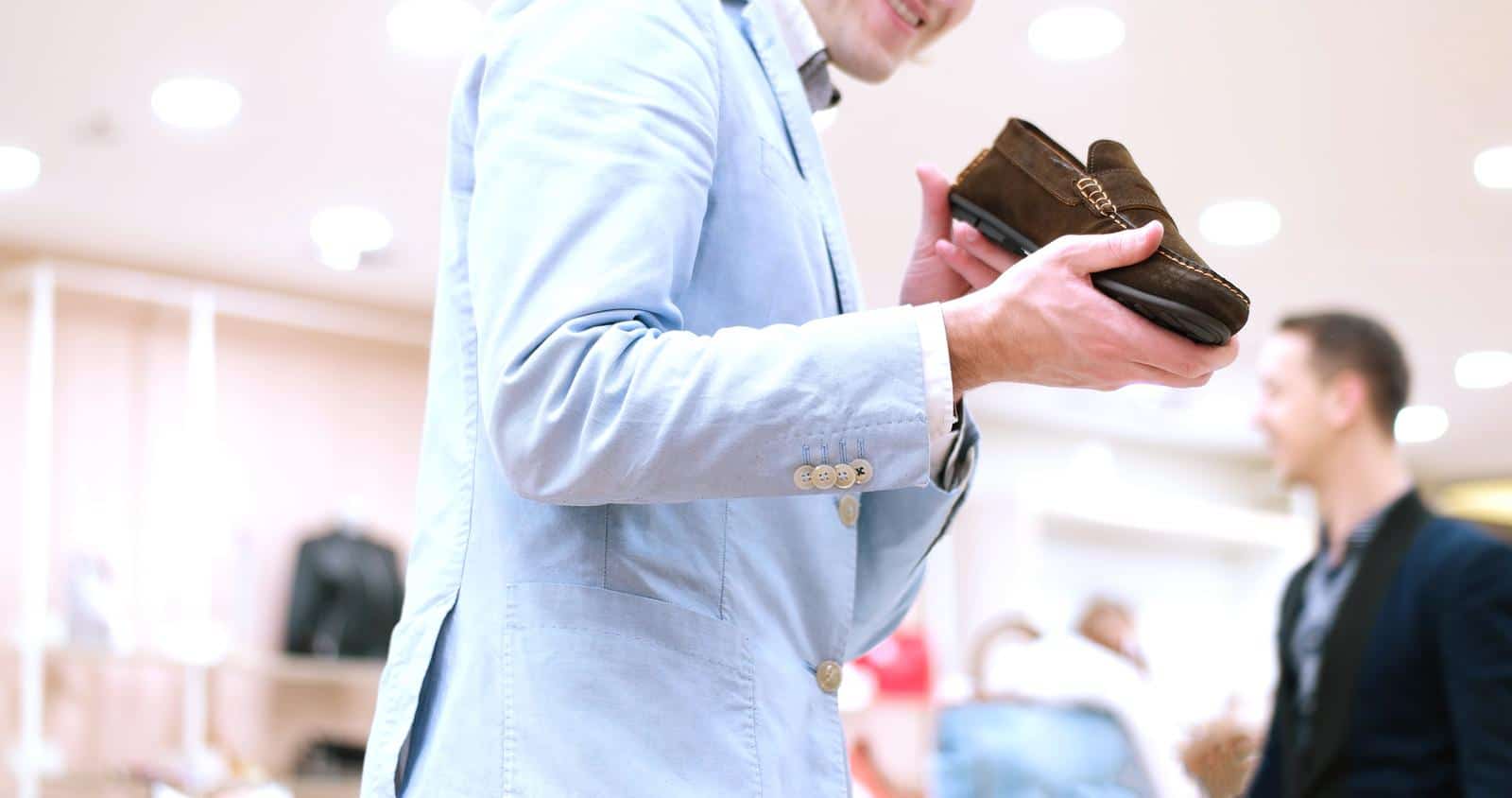 Man Chooses Shoes At Shoe Store